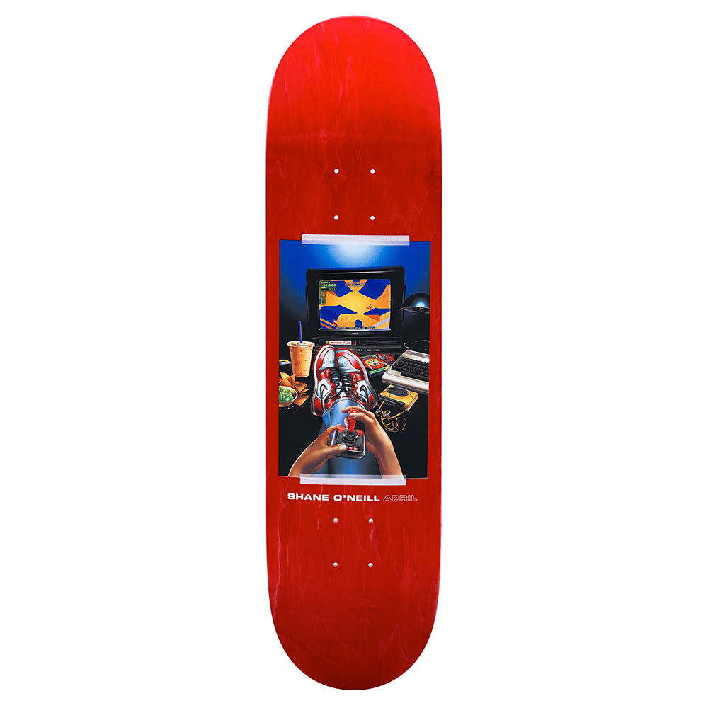 The APRIL SHANE O'NEILL VINTAGE 2 by APRIL is a red skateboard deck with artwork of hands tying laces in front of a monitor, keyboard, and snacks. "SHANE O'NEILL APRIL" is printed at the bottom.