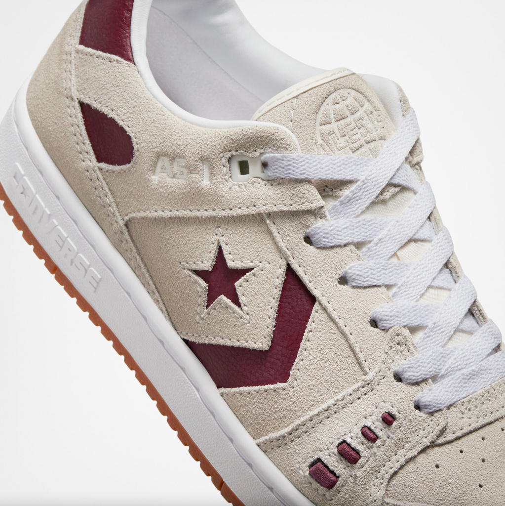 A white and red Converse sneaker with a star on the side.