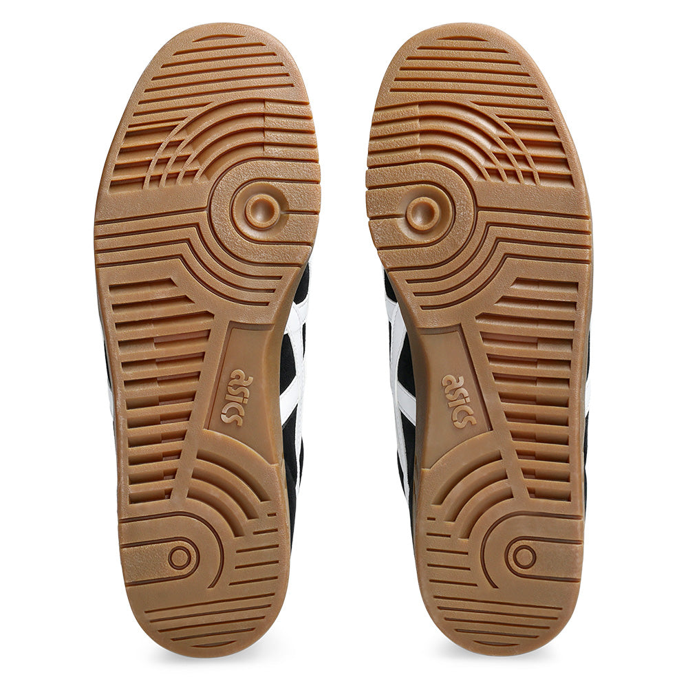A pair of ASICS GEL-VICKKA PRO BLACK / BROWN sneakers shown from the bottom, featuring tan rubber outsoles with textured grip patterns, skateboard specs, and the ASICS logo.