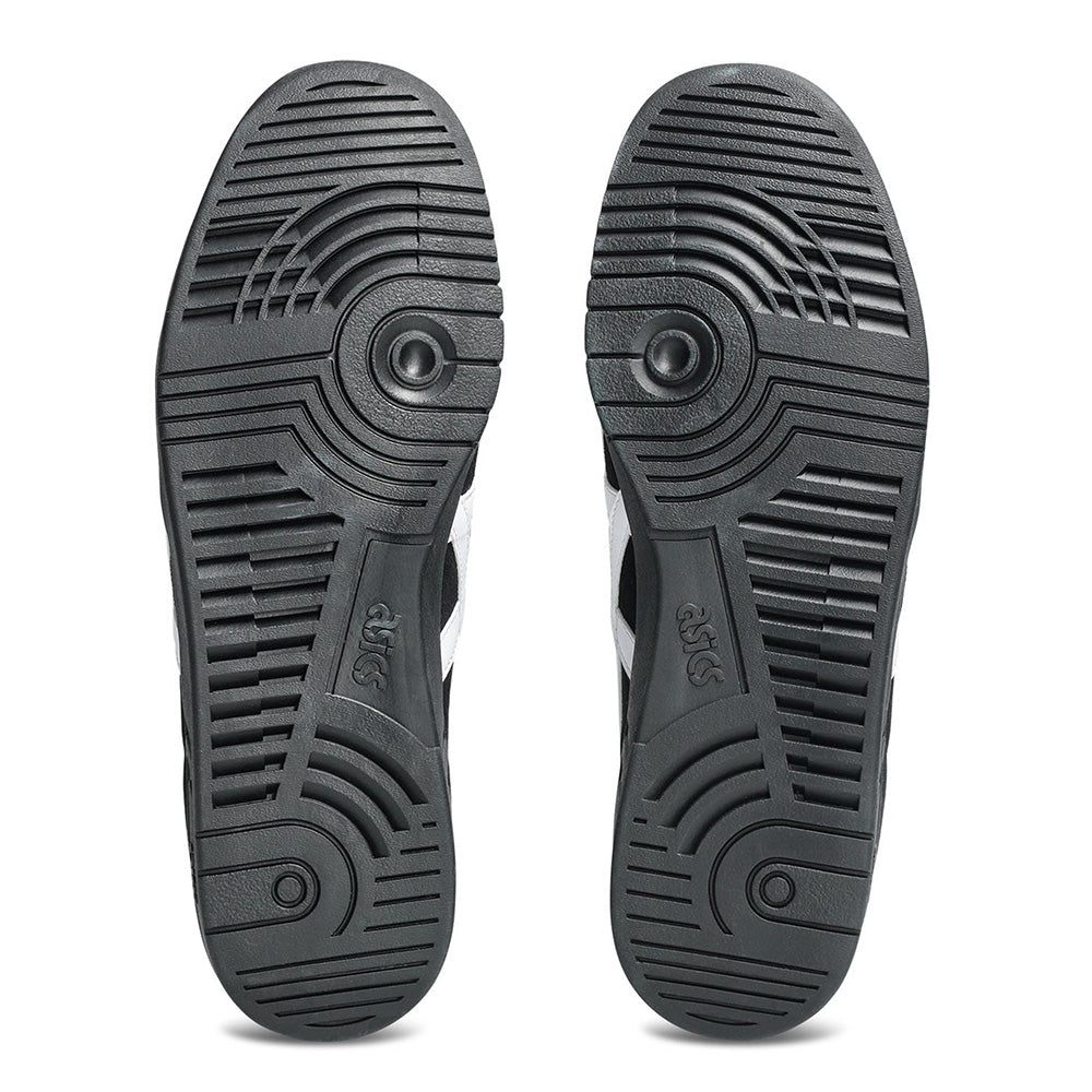 Bottom view of ASICS GEL-VICKKA PRO BLACK / BRIGHT WHITE skate shoes, showing patterned rubber soles with circular treads and the ASICS logo, highlighting advanced GEL technology for superior comfort.