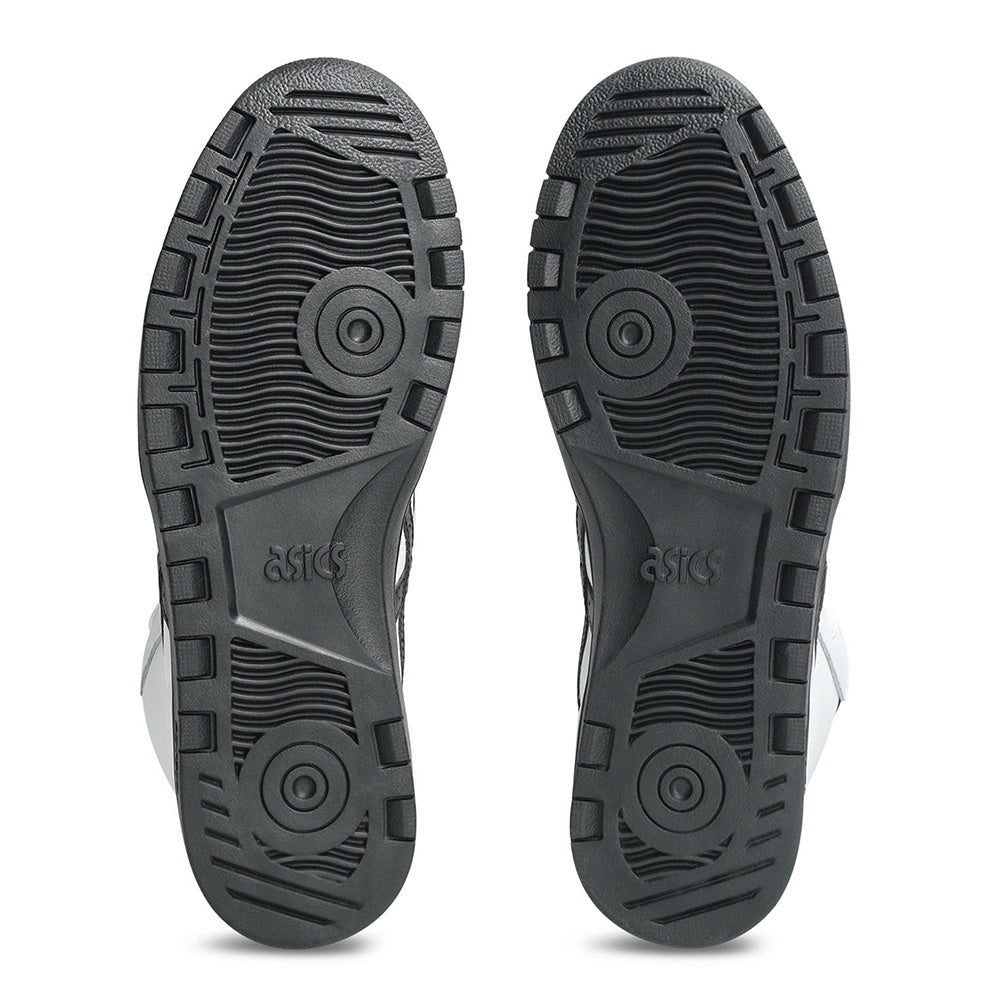 Pair of black rubber outsoles with circular tread patterns and ASICS logo, made for the ASICS JAPAN PRO MID WHITE / BLACK skateboarding shoe, shown from below against a white background.