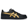 The ASICS JAPAN PRO BLACK / PURE GOLD skateboarding shoe features a textured surface with gold stripes and suede paneling.