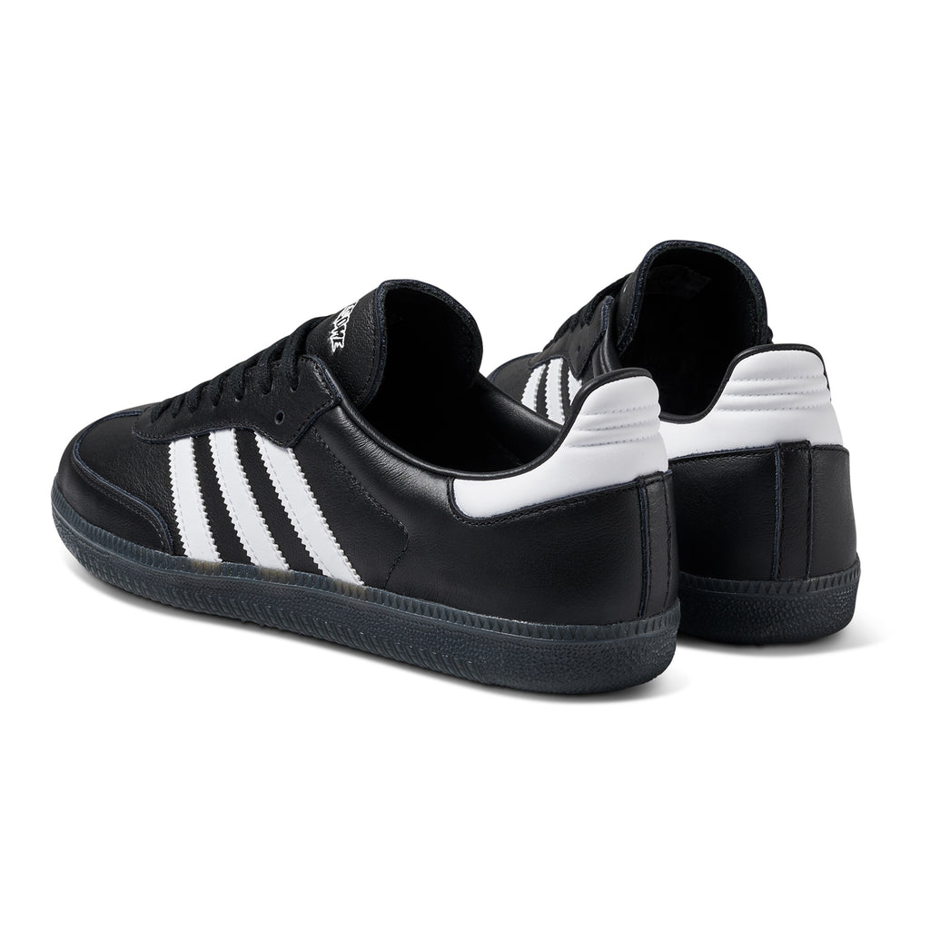 A pair of black and white ADIDAS X FUCKING AWESOME SAMBA sneakers.