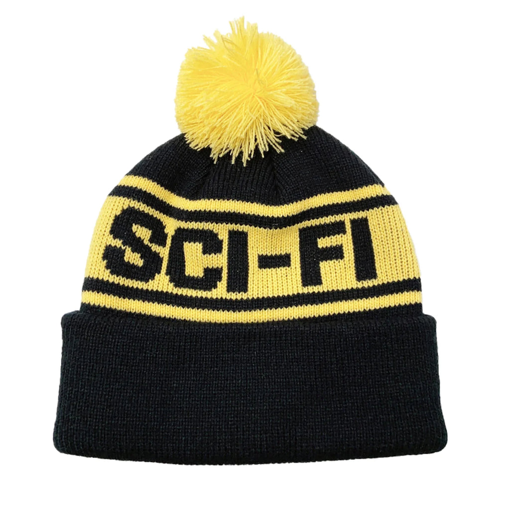 A SCI-FI FANTASY black and yellow pom beanie with the word sci-fi on it.