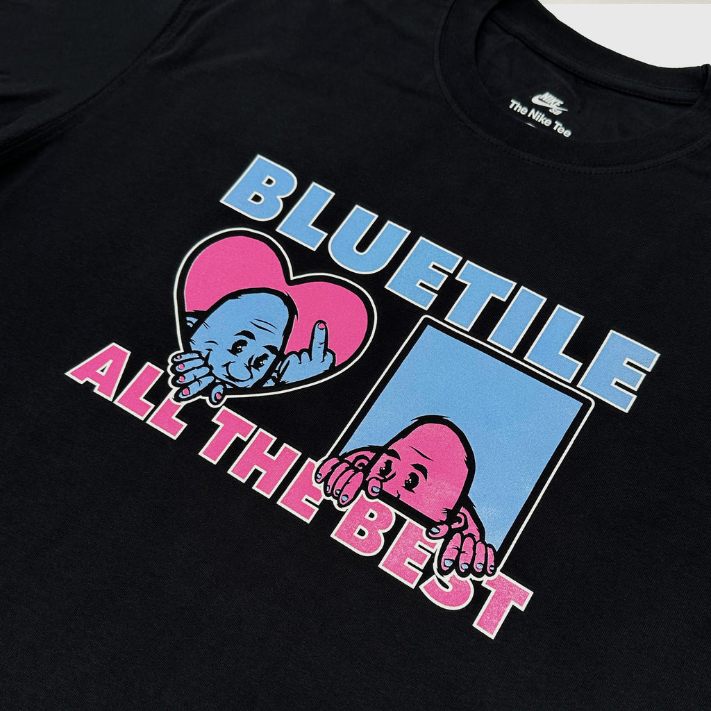 The BLUETILE F.U.W.T.F. TEE BLACK by Bluetile Skateboards is a black screen-printed T-shirt that showcases a graphic with two cartoon characters—one inside a heart and the other inside a square—with the text "BLUETILE" above and "ALL THE BEST" below. This tee is part of our exclusive HEART OF COLUMBIA TEE collection.