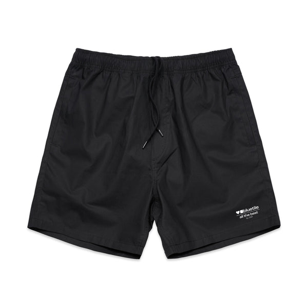 The BLUETILE SURPLUS V3 BEACH SHORT BLACK by Bluetile Skateboards are made of cotton and include an elastic waistband with a drawstring, featuring small logo text and icons on the lower right leg.