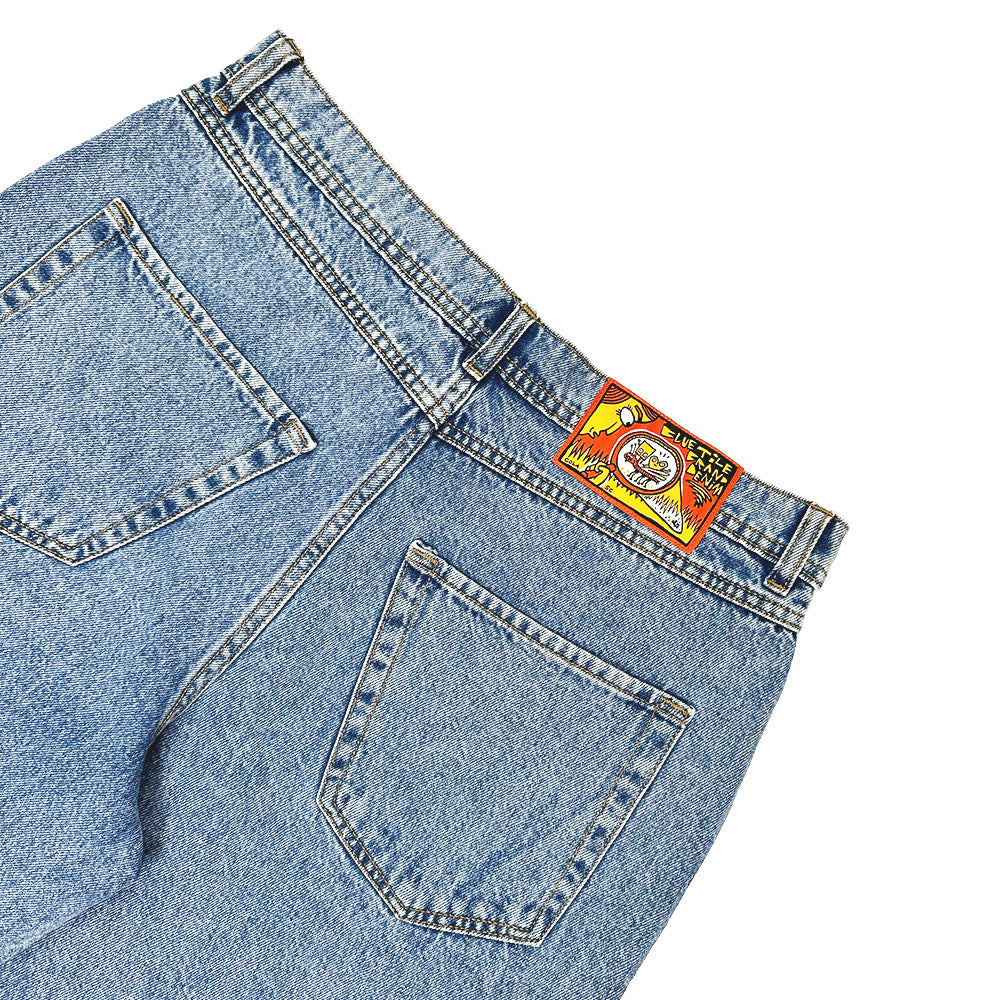 A pair of blue Bluetile Skateboards Rutledge Jorts shown from the back, featuring two rear pockets, a colorful waistband label, and a loose fit.