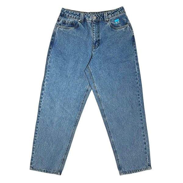 The BLUETILE BRAND DENIM RUTLEDGE PANT BLUE from Bluetile Skateboards is a pair of blue, loose fit 100% cotton denim with five pockets and a small blue patch on the right pocket.