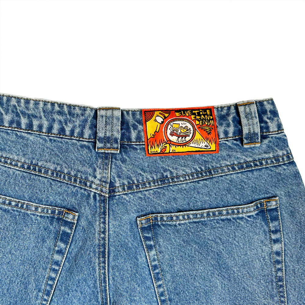 Back view of BLUETILE BRAND DENIM RUTLEDGE PANT BLUE by Bluetile Skateboards, 100% cotton, with a colorful "LIVE TITE JEAN DENIM" patch featuring a graphic above the right pocket.