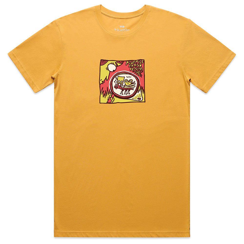 The BLUETILE DENIM BRAND TEE GOLD by Bluetile Skateboards is a mustard yellow 100% combed cotton tee with a colorful square chest graphic of cartoon characters and abstract shapes.