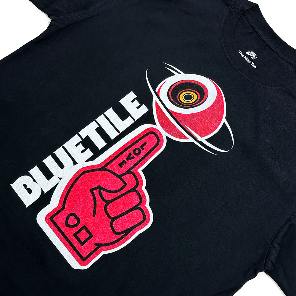 The BLUETILE FRIENDLY RED FOAM FINGER TEE BLACK, by Bluetile Skateboards, has a red pointing hand graphic, "BLUETILE," and a Saturn-like planet on heavyweight cotton for a loose fit akin to the Nike SB Loose Fit Tee.