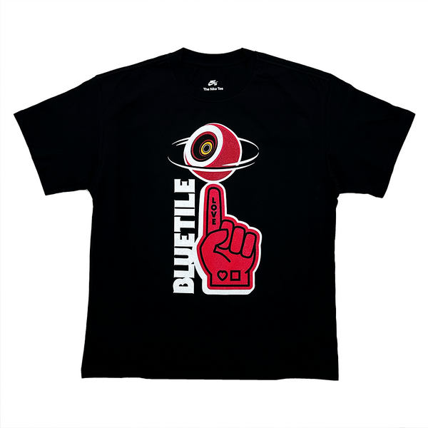 Introducing the BLUETILE FRIENDLY RED FOAM FINGER TEE BLACK by Bluetile Skateboards, a heavyweight cotton navy T-shirt featuring a bold graphic with a red fist, hovering eyeball, and "BLUETILE" in bold letters.