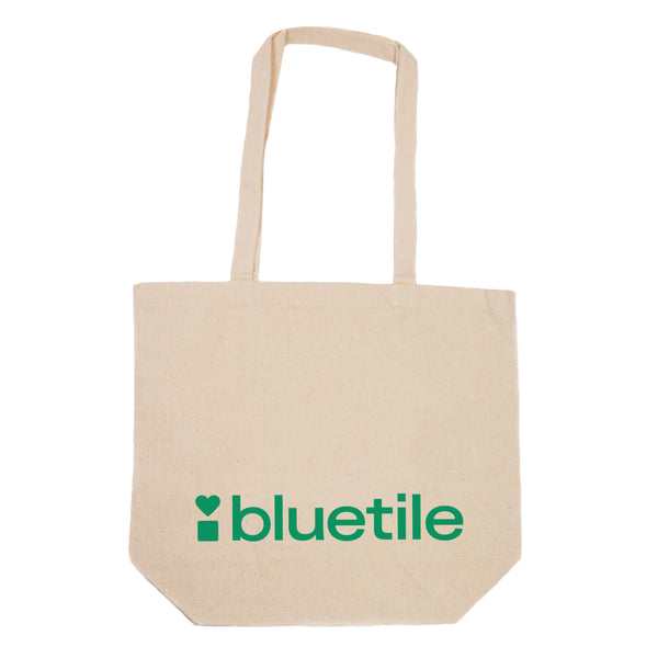 Canvas tote bag with Bluetile Skateboards BLUETILE GREEN LOGO TOTE printed on the side.