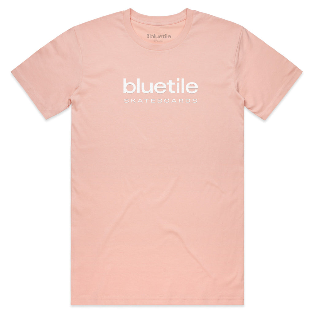 A pale pink Bluetile Puff Logo Tee featuring "Bluetile Skateboards" printed in white on the front, capturing a breezy seafoam vibe.