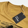 A Bluetile Skateboards "Razors" tee faded mustard with a tag that says love the blues.