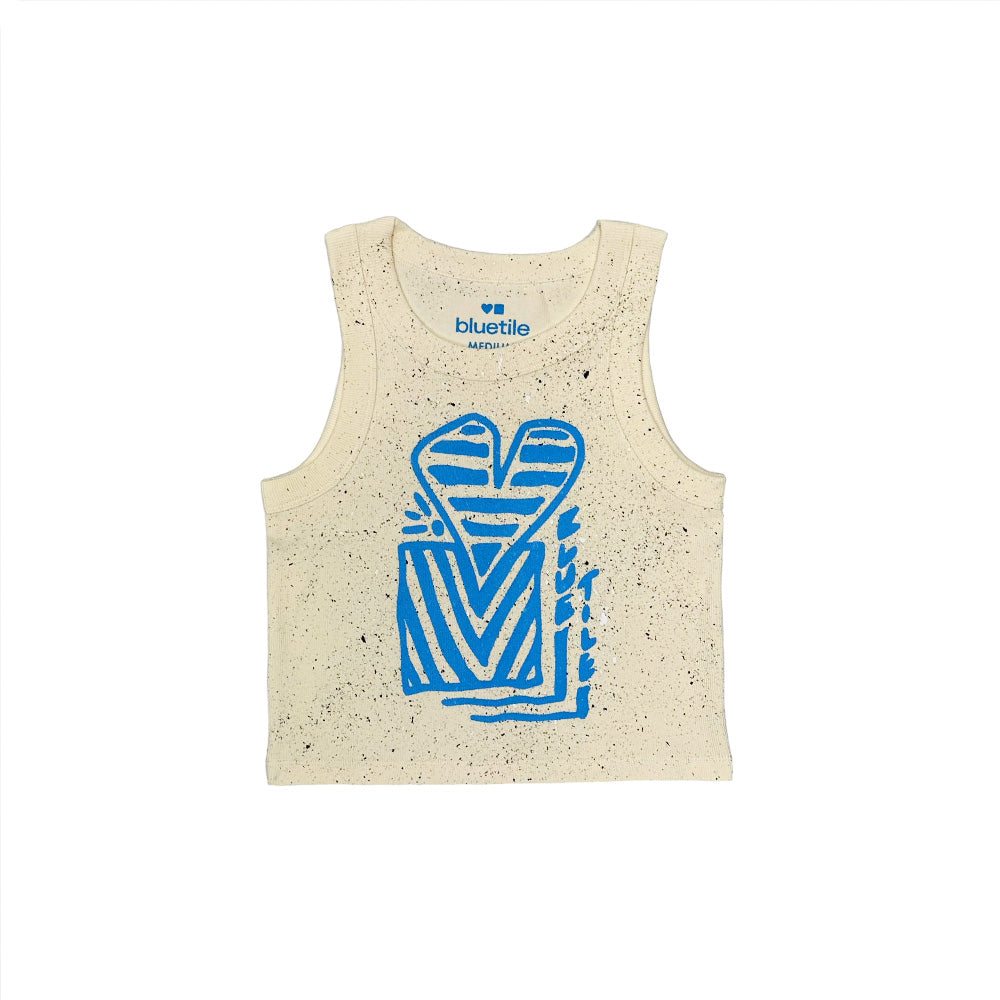 The BLUETILE HEART + SQUARE RIB CROP TANK ECRU by Bluetile Skateboards is a sleeveless beige ribbed crop top with black speckles and a blue abstract front graphic. Features a Stacked Logo label at the neckline and is made from 100% cotton for comfort.