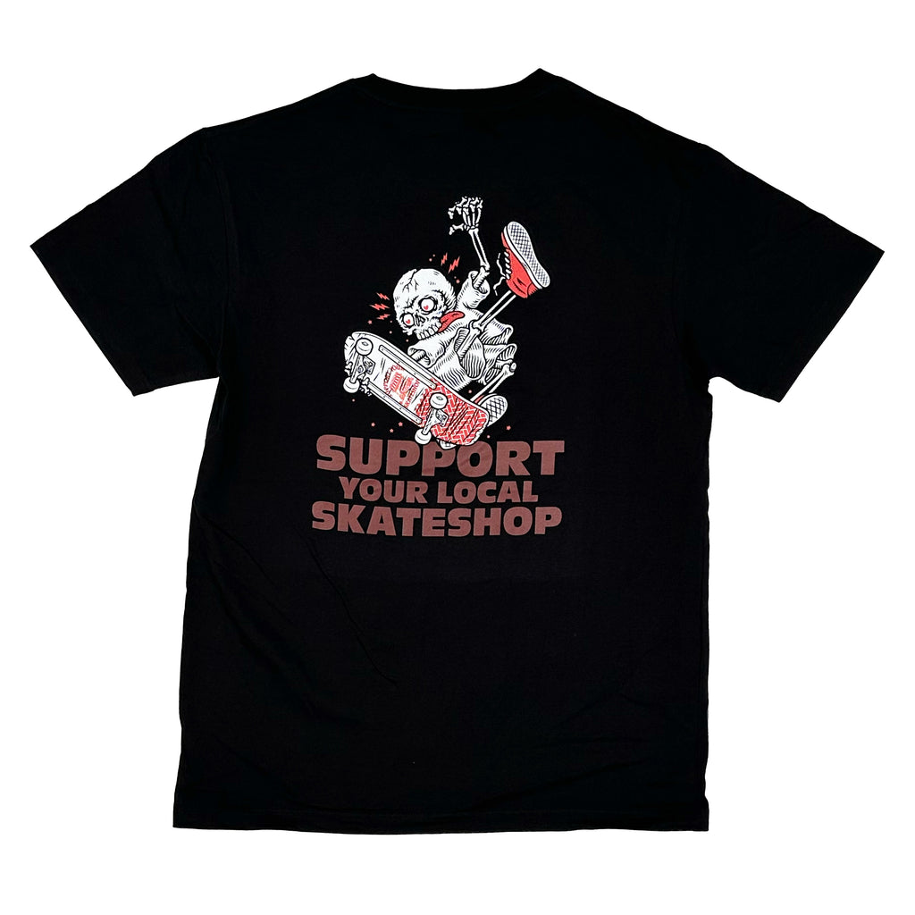 The BLUETILE X SKATE SHOP DAY ONE FOOT TEE BLACK by Bluetile Skateboards features a stone-washed black design with a skeleton, skateboard, and soda. "SUPPORT YOUR LOCAL SKATESHOP" pops in white and red, making it more than just a tee—it's an edgy statement piece for fans.