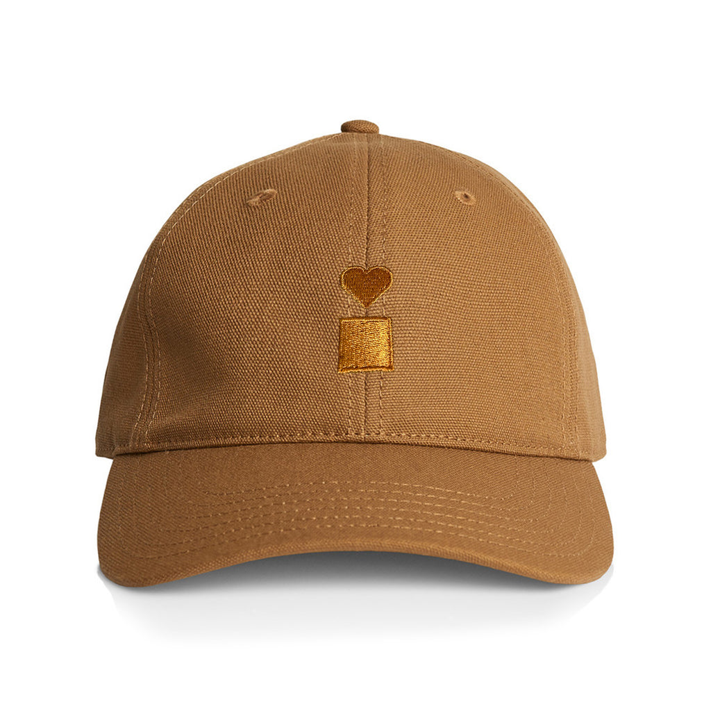 The BLUETILE STACKED LOGO CANVAS HAT CAMEL by Bluetile Skateboards is a camel-colored canvas baseball cap, made from 100% cotton. It features a charming small heart and rectangle design embroidered on the front, with an adjustable fastener to ensure a perfect fit for any head size.