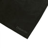 Close-up of the BLUETILE LOGO SWIM SHORTS BLACK by Bluetile Skateboards, showing the lower corner in quick-dry fabric with the subtle dark gray Bluetile logo.