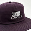 A BLUETILE "RAZOR" CLASSIC HAT PLUM with the word Bluetile Skateboards on it.