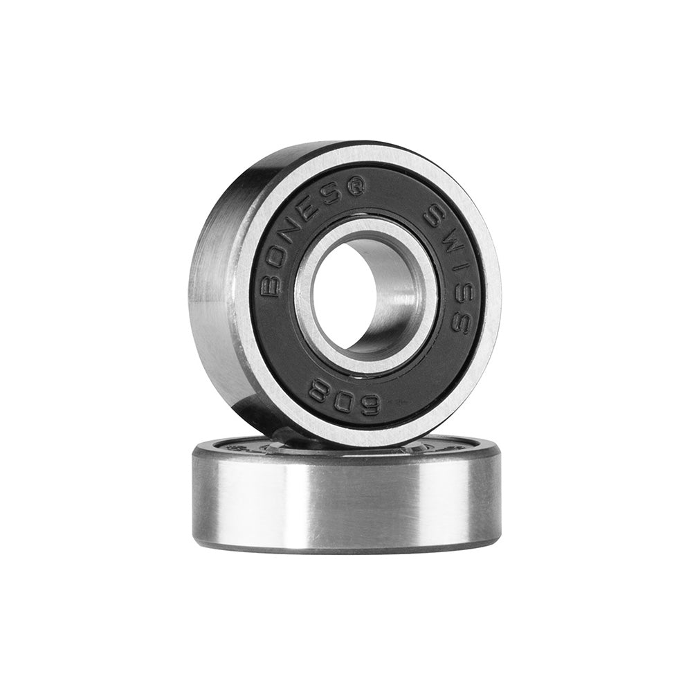 Two BONES SWISS PRECISION BEARINGS, one upright and one flat on a white background, display "Bones Swiss" engraved rims. These BONES bearings offer pre-lubrication and high speed nylon cages for smooth, reliable performance.