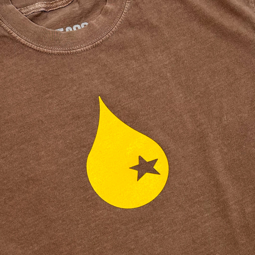 A close up of a yellow raindrop with a star cutout in the middle.
