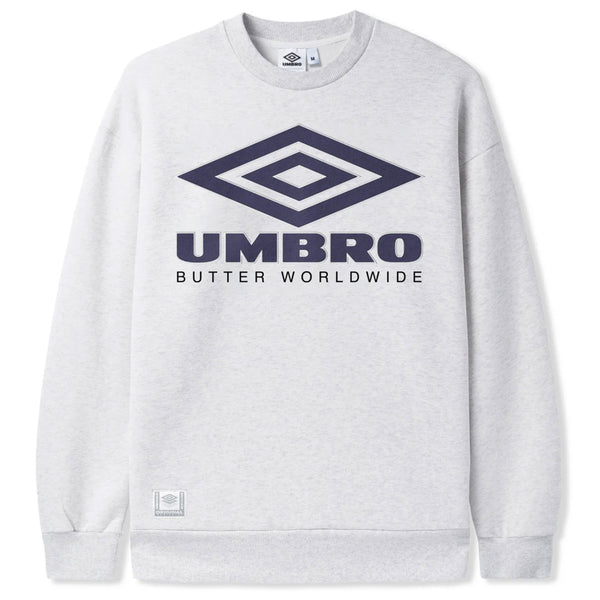 Butter Goods X Umbro Diamond Logo Crewneck in ash, showcasing a navy Umbro logo and "Butter Worldwide" text, adorned with detailed embroidery.