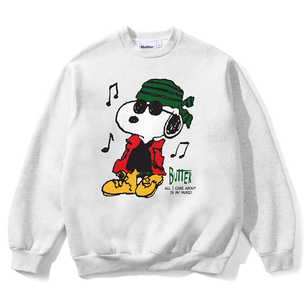 The BUTTER X PEANUTS MUSIC CREWNECK ASH by Butter Goods features Snoopy in sunglasses, green bandana, red jacket, and yellow boots with music notes and “Butter, All I Care About Is My Music.” Perfect for fans!.