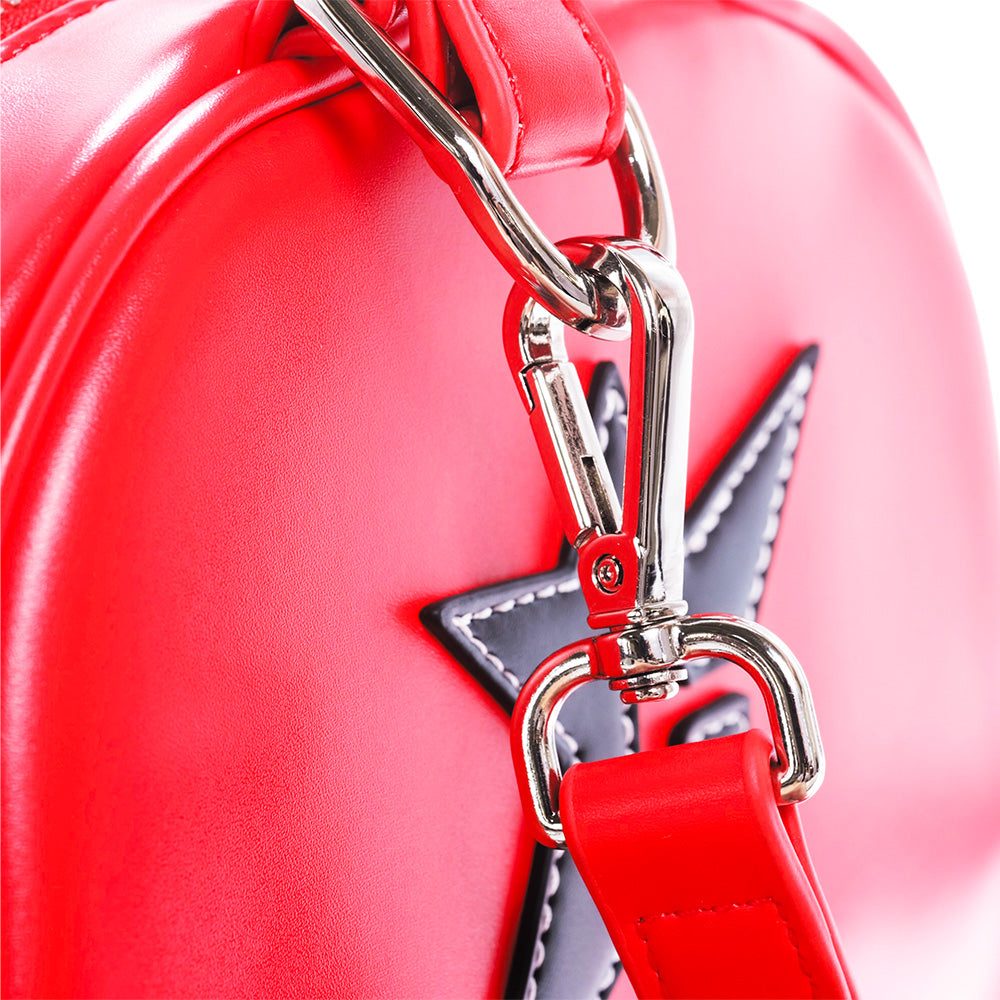 Close-up of the Carpet Co. CARPET CO. C-STAR PURSE RED, featuring red leather, a silver metal clasp, and a black star-shaped patch for standout style.