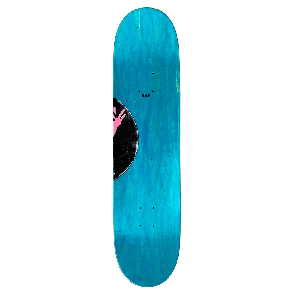 The Carpet Co. CARPET VINYL deck, in turquoise, features a pink hand symbol and a black circular design like Egyptian carpets. It includes pre-drilled holes for easy truck attachment, ensuring the perfect wheelbase for your ride.