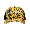 The Carpet Co. Trucker Cheetah hat features yellow and black cheetah embroidery, "CARPET" in white on the front, and a breathable mesh back.