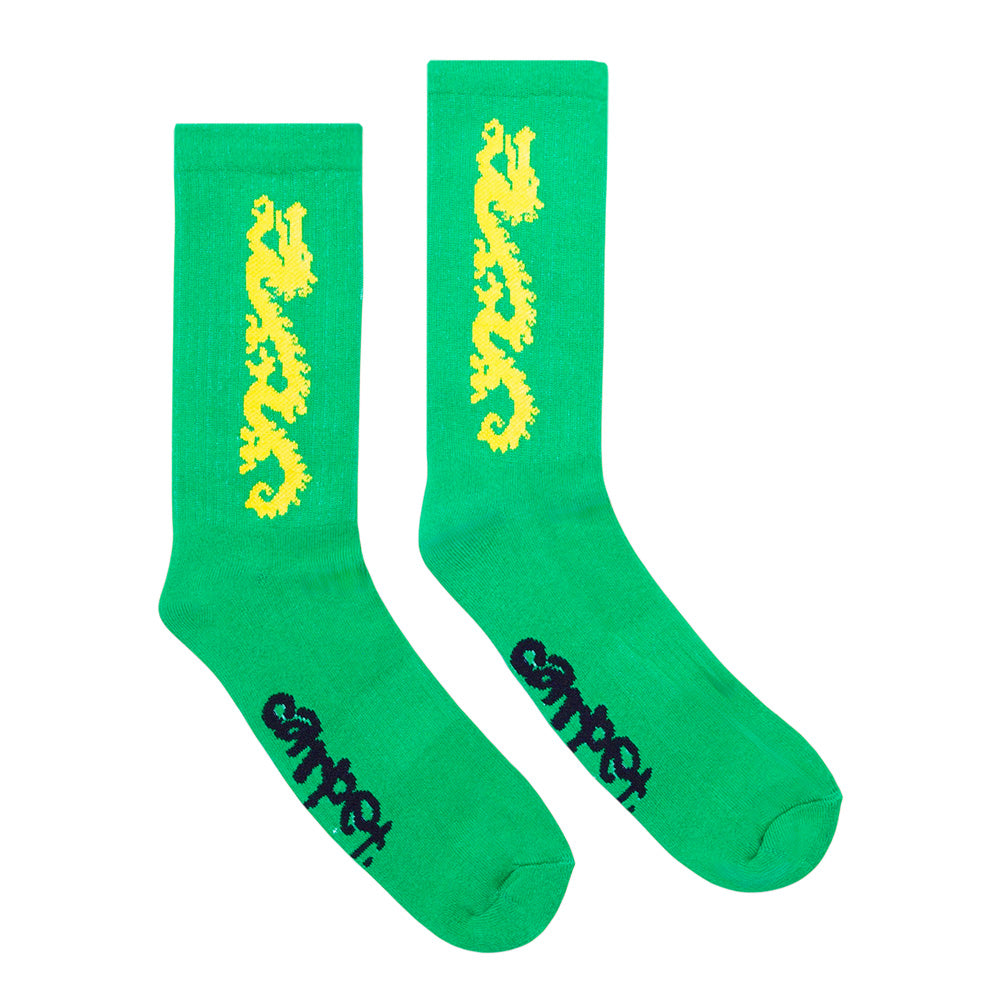 The STANCE CARPET CO. DRAGON SOCK GREEN features bright green fabric, custom yellow dragon artwork with vertical detailing, and black “carpet” text near the toes.