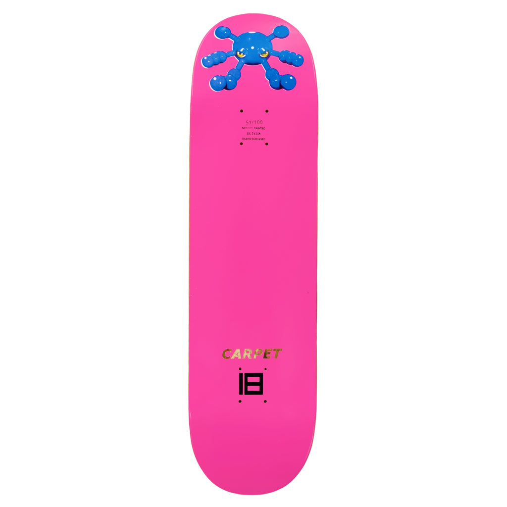 The CARPET BACTERIA skateboard deck by Carpet Co. showcases a striking bright pink deck with a blue abstract design at the top and the words "CARPET COMPANY" in gold letters near the bottom, blending vibrant base colors for an eye-catching look.