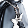 Close-up of a metal clasp attaching a black strap to the Bluetile Skateboards CARPET CO. C-STAR PURSE BLACK, featuring a bold white star patch.