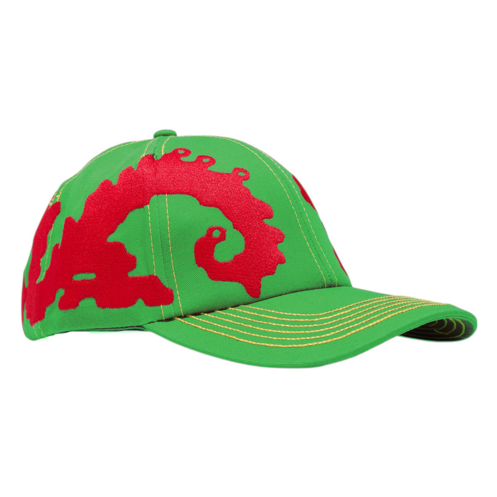 The Carpet Co. CARPET CO. DRAGON HAT GREEN features yellow-stitched brims and bold red abstract patterns on front and side panels, inspired by the iconic Dragon Hat design.
