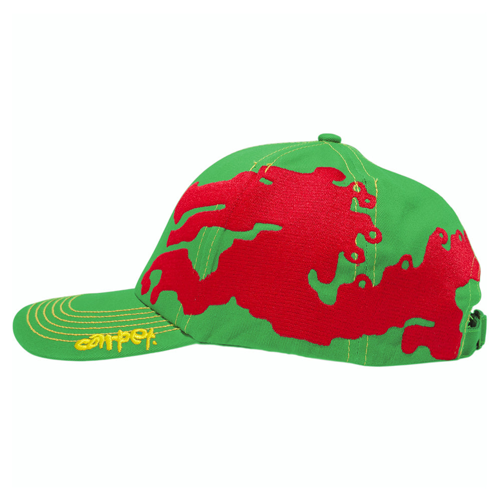 The CARPET CO. DRAGON HAT GREEN by Carpet Co. features an abstract red pattern on the side and yellow embroidered letters on the brim, making it a bold choice for standing out.