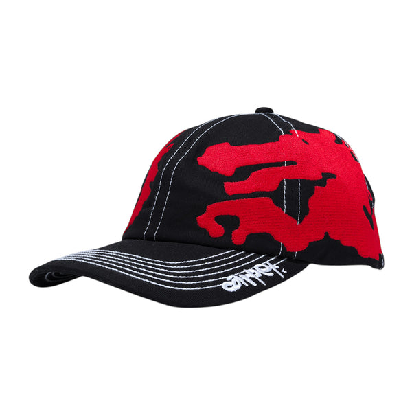 The CARPET CO. DRAGON HAT BLACK by Carpet Co. is a black snapback baseball cap with bold red abstract shapes, white stitching, and a small white logo on the brim—an eye-catching embroidered design inspired by the Dragon Hat style.