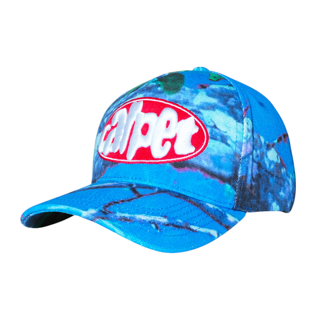 Blue hat featuring a tie-dye pattern with a red and white oval "Adpet" logo on the front, reflecting the vibrant style of Carpet Co.'s Carpet Co. Realtree Hat Blue.