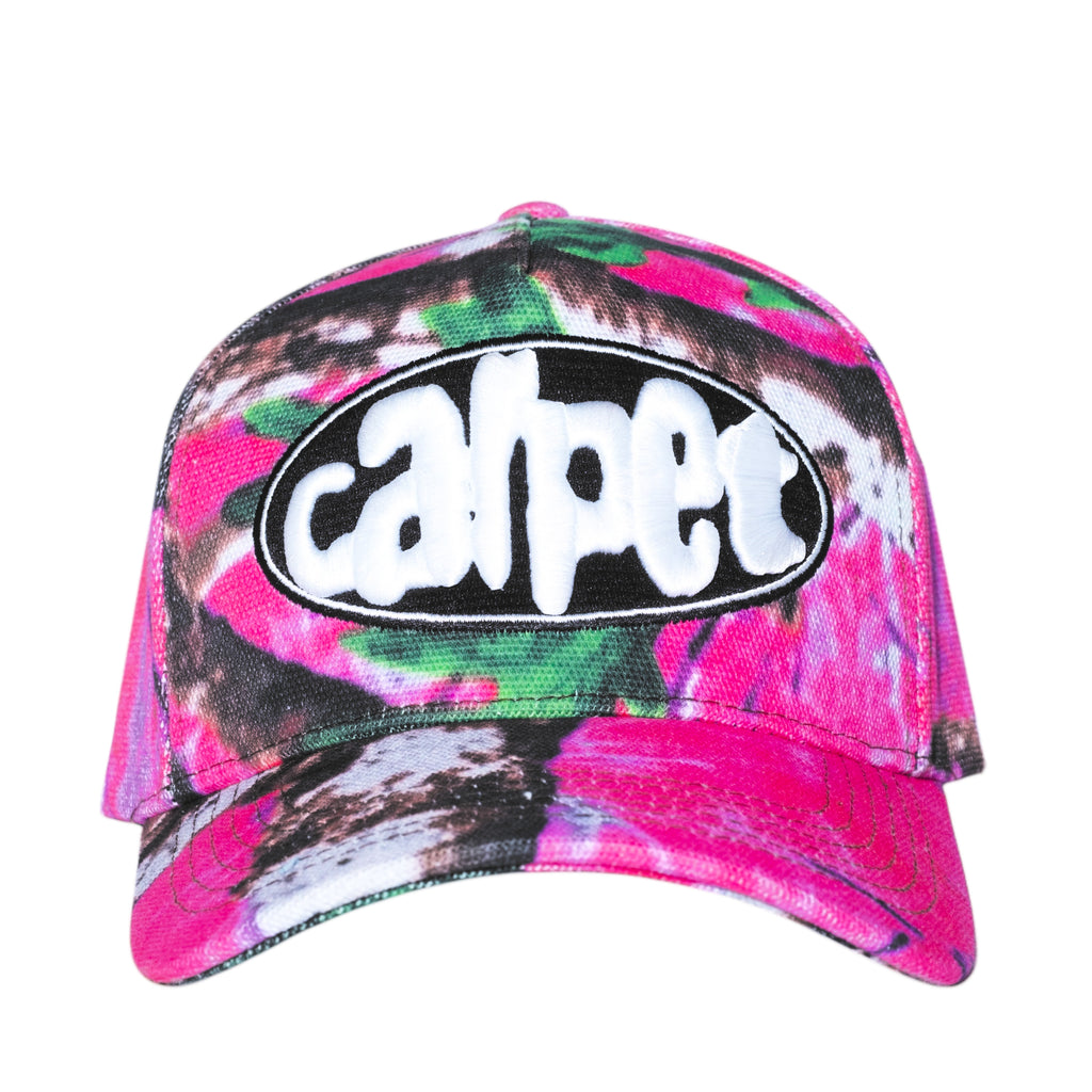 The Carpet Co. Realtree Hat Pink features a vibrant pink, green, and dark color scheme with a distorted oval patch that says "carpet" in white rounded font, making it an ideal choice for those seeking a bold fashion statement.