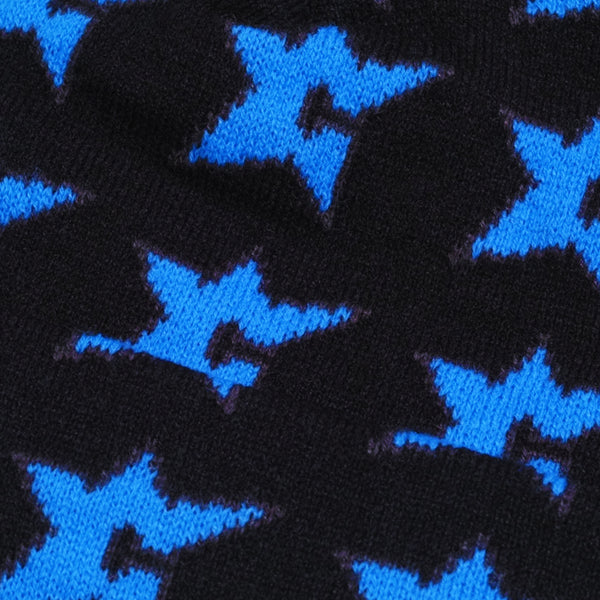 Close-up of the CARPET CO. C-STAR BEANIE BLACK by Carpet Co., featuring a knitted cotton fabric with a blue star pattern on a black background.