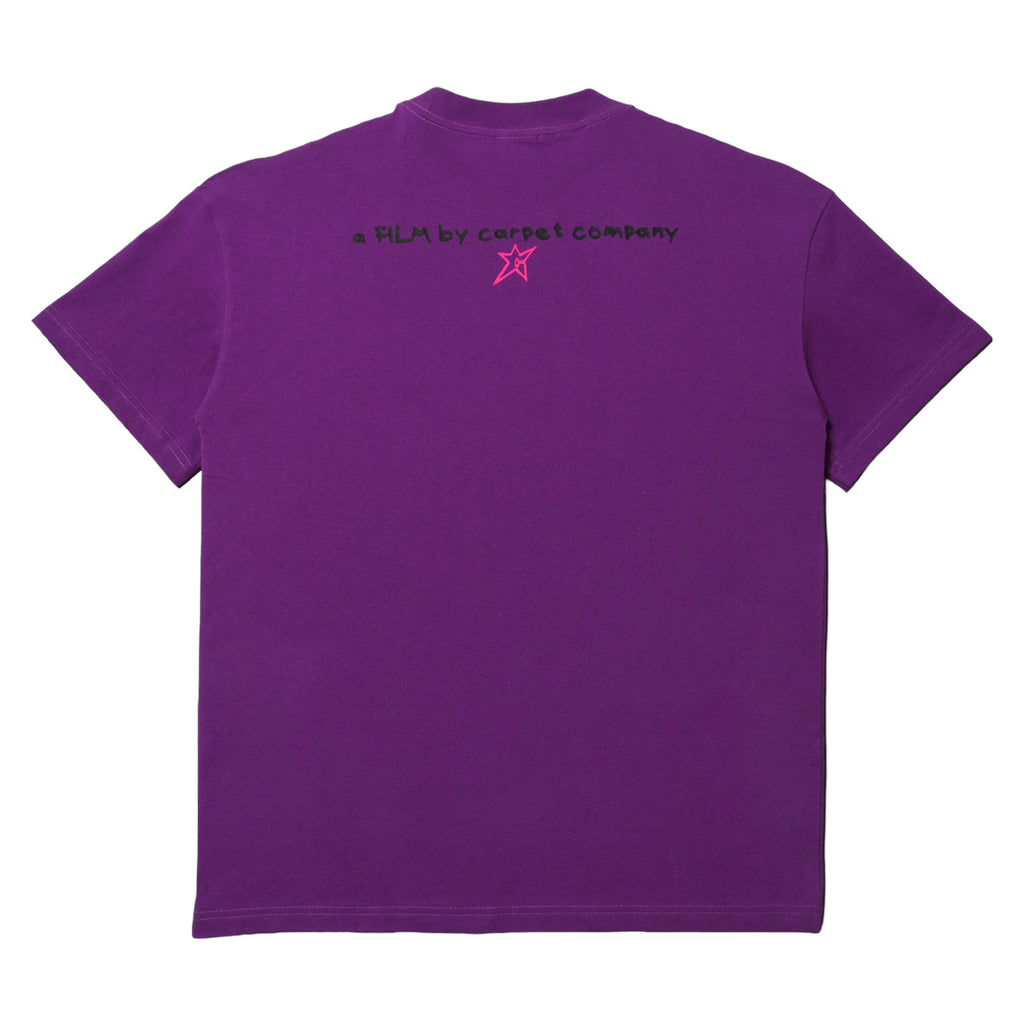 CARPET CO. BRAT TEE PURPLE with the text "a film by Carpet Co." and a small pink star design on the back.
