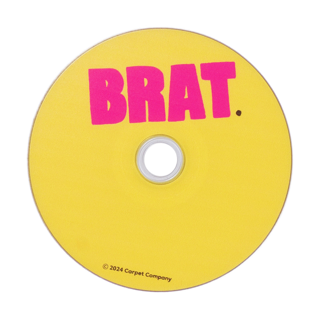 Yellow CARPET CO. BRAT DVD with the word "brat." in pink letters, branded with "©2024 carpet company" at the bottom and a strap back design.