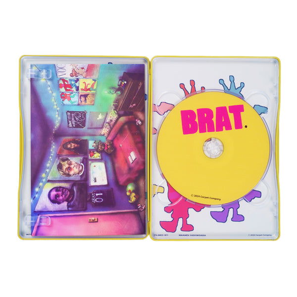 Cd case open displaying a vibrant disc labeled "Carpet Co. BRAT DVD" and a colorful cover art with various whimsical designs and pictures, including a black denim hat.