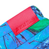 Close-up of a colorful fabric featuring a vivid red label that says "Carpet Co.," reminiscent of the dynamic patterns often found in Realtree designs, as seen on the Carpet Co. Realtree Pant Blue.
