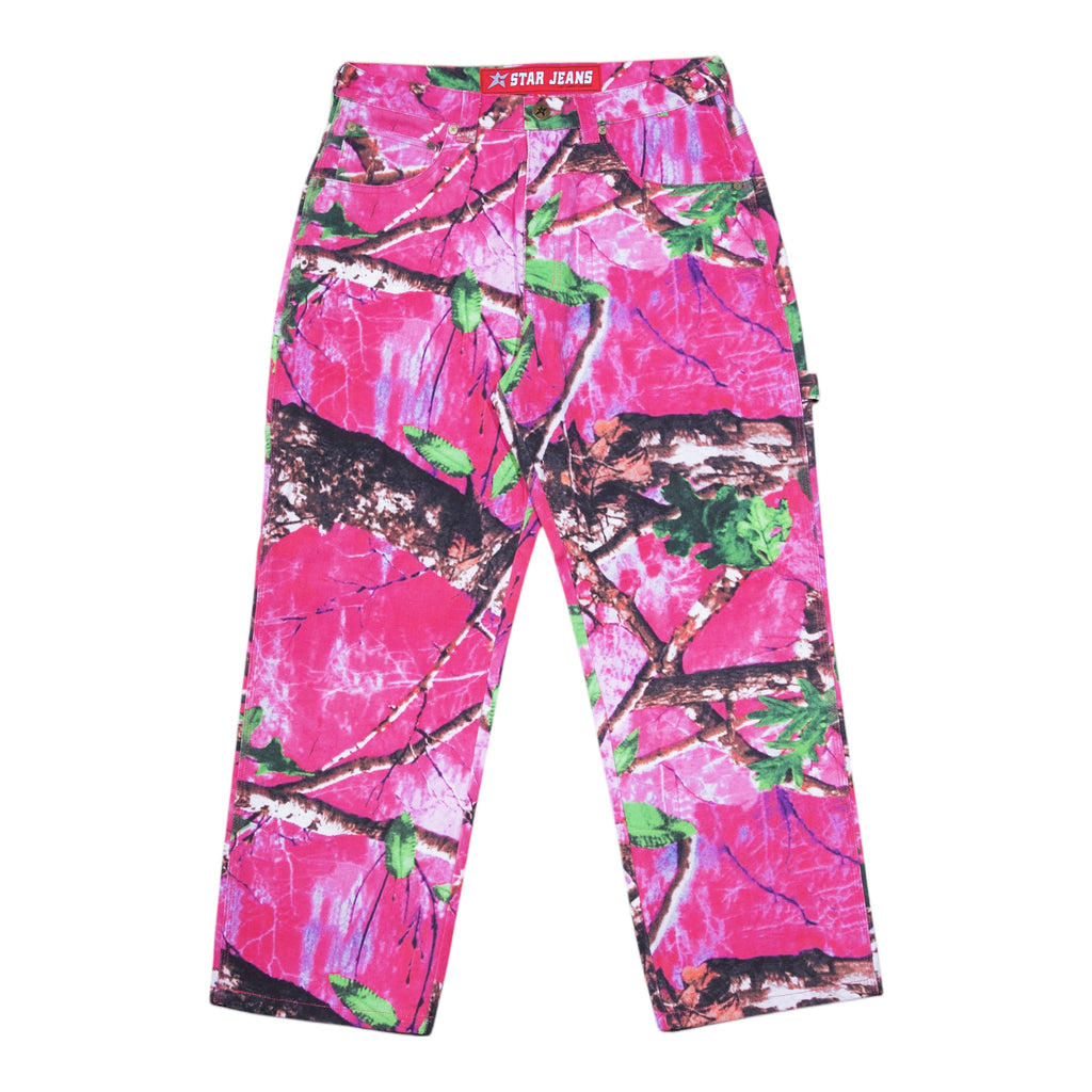 The Carpet Co. Realtree Pant Pink are bright pink camouflage pants with green and brown accents, featuring the "Star Jeans" label at the waistband, perfect for making a statement whether in the wild or on the street.