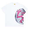 The CARPET CO. VINYL TEE WHITE by Carpet Co. features a screen-printed pink abstract figure against an oval dark backdrop on the right side, with "Carpet Company 2023" text near the bottom, creating a unique design.