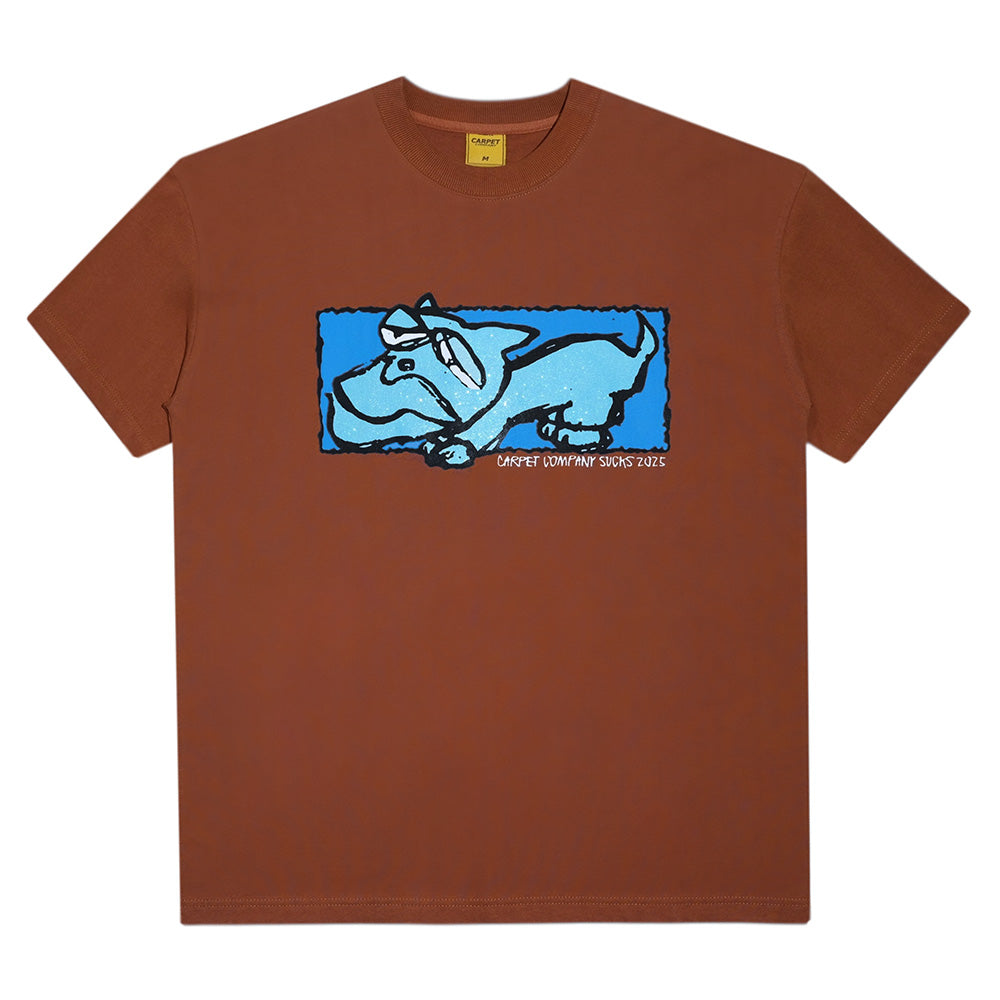 The Carpet Co. DOG TEE BROWN features a cartoon blue and white dog graphic with "Carpet Company Sucks 2023" on the front—a unique pick for fans of standout shirts.