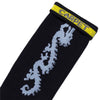 The STANCE CARPET CO. DRAGON SOCK BLACK features custom art—a light blue dragon and a yellow cuff with bold blue "CARPET" lettering—ideal for fans of unique and stylish dragon socks.