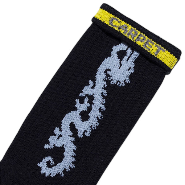 The STANCE CARPET CO. DRAGON SOCK BLACK features custom art—a light blue dragon and a yellow cuff with bold blue "CARPET" lettering—ideal for fans of unique and stylish dragon socks.