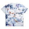 The CARPET CO. RAG TEE by Carpet Co. features a white base with multicolored paint splatters, abstract designs, and "LOVE" in bold on the lower back—pair it with black denim for an artistic statement look.